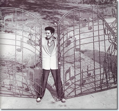 Elvis standing at the music gate that was custom designed and built for him. The gate was installed in 1957 shortly after Elvis moved into the home. 