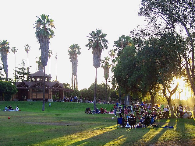 People gather at the lawn surrounding the park's amphitheater.