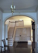 Photo of the main staircase foyer which demonstrates a distinctive slant at the top of the stairway. Due to a lack of skilled labor there are numerous examples of craftsmanship errors throughout the house.