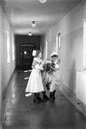 Nurses holding a patient.