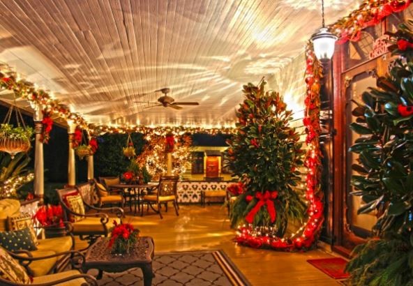 The mansion's porch decorated for Christmas.