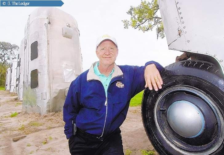 Picture of Frank Bates beside one of the RVs