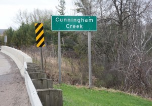 Sign and bridge over over Cunningham Creek