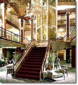 The hotel lobby is built around the glass elevator shaft and includes a historic plaque marking the high water mark of the 1938 hurricane.