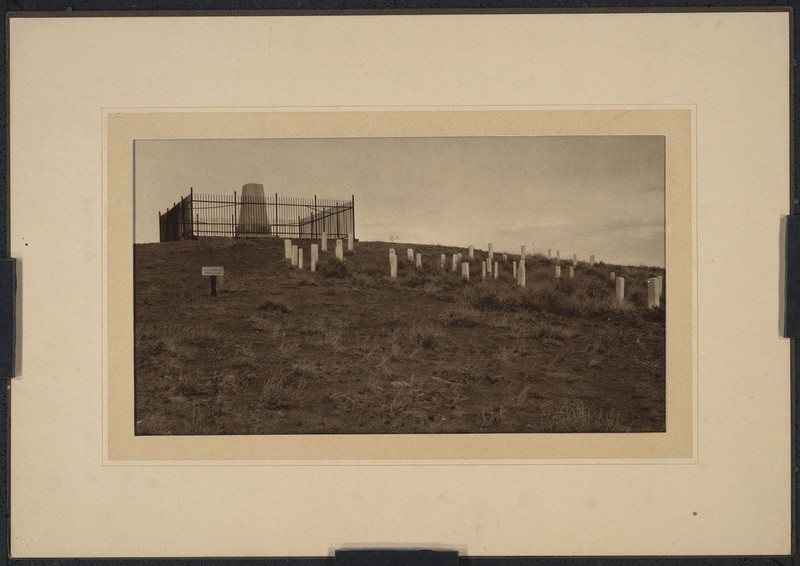 The monument is seen in the center surrounded by the grave sites of the men of the 7th Regiment.