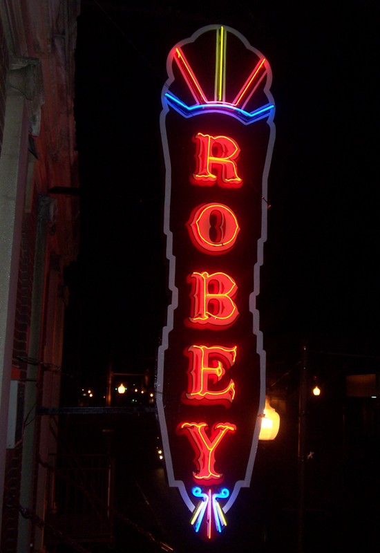 The theatre sign lit up at night.