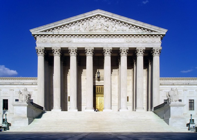 The Supreme Court Building declares "Equal Justice Under Law," with images of Liberty, Roman soldiers representing Order and Authority, architect Cass Gilbert, and other political figures. 