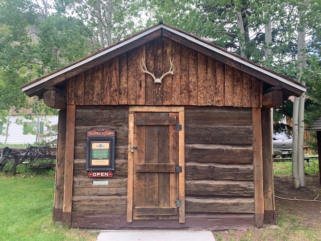 A modern day view of the Trapper's Cabin.Every few years the buildings are coated with brown sealant on the bottom two or three logs. 