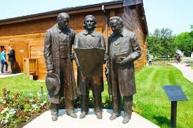 Statue in front of the tabernacle depicting the new First Presidency mapping out the encampments of the church in the area. L-R: Heber C. Kimball, Brigham Young and Willard Richards