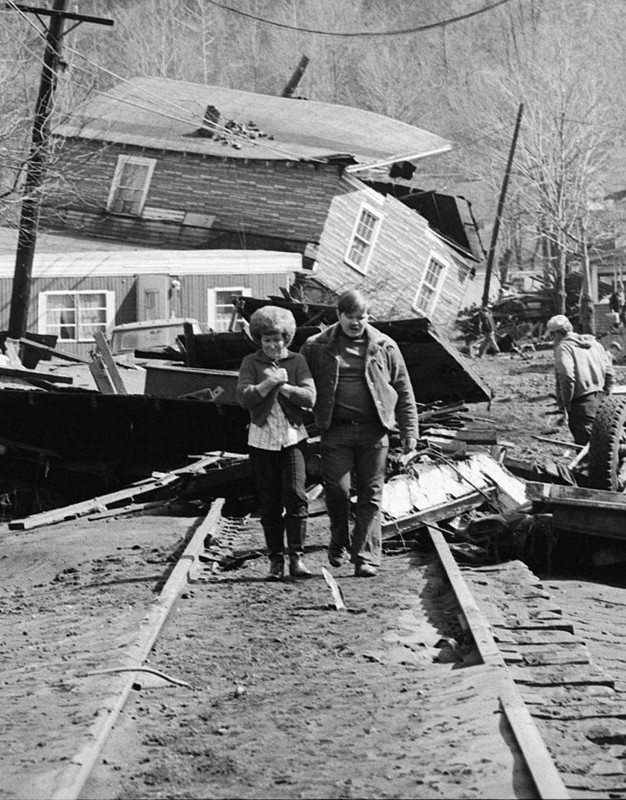 People after the flood. It destroyed railroad tracks also, as you can see.