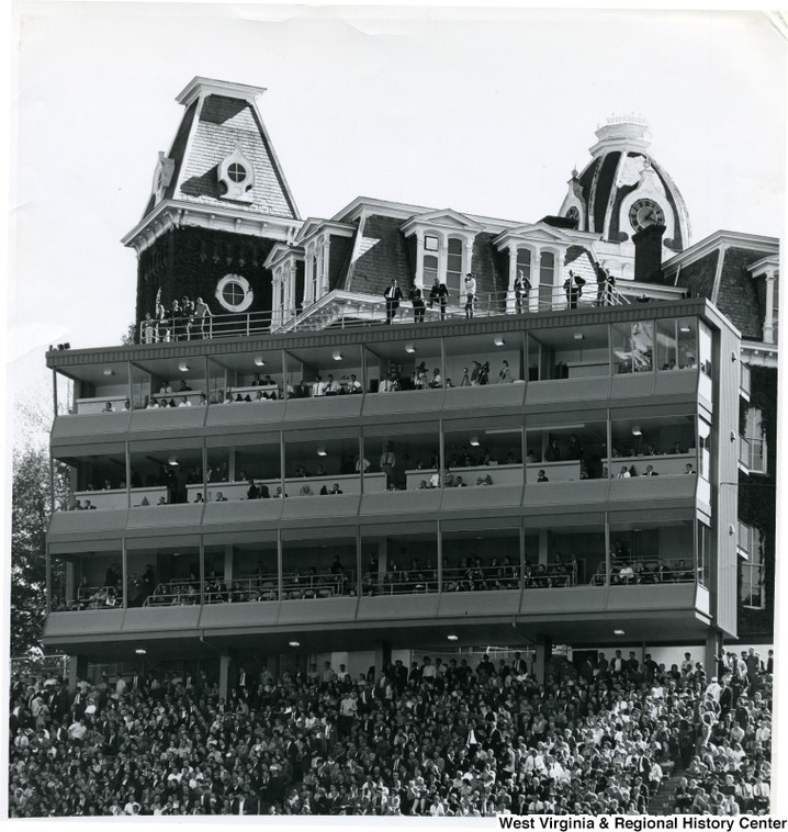 Woodburn Hall stands behind the old Mountaineer Field stadium and press box.