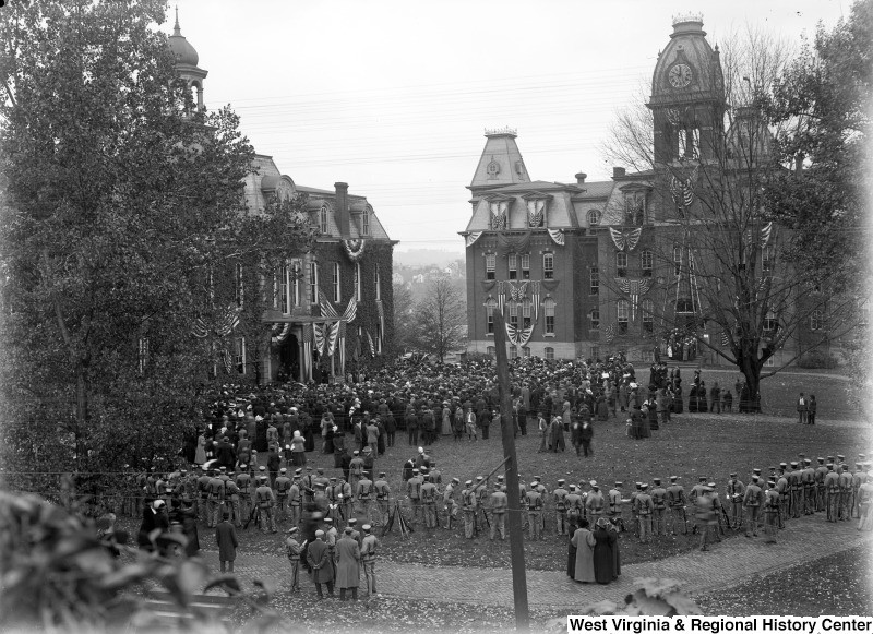 Crowds gather outside Woodburn Circle to welcome United States President William Taft in 1911. Patriotic banners adorn Woodburn Hall and its neighbor, Martin Hall.