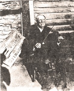 George Abner Power with his fiddle, behind his house in Land Lot 217 (Power Family Collection).