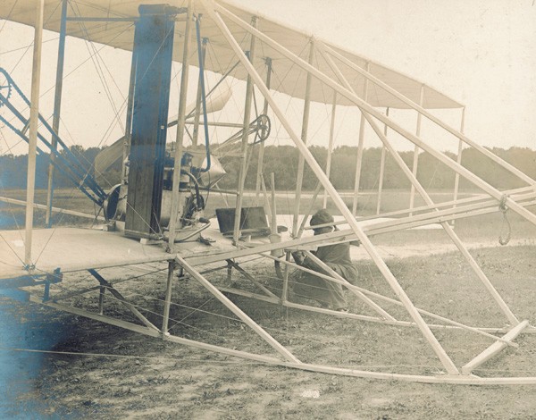 Charles Taylor pictured working on a Wright Model A Flyer, c.1908