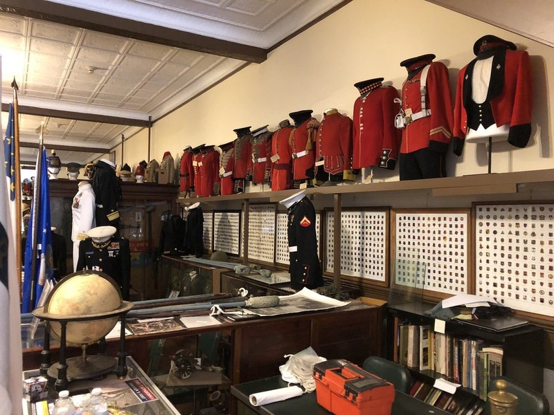 Various military uniforms and other artifacts in the museum's storage space. 