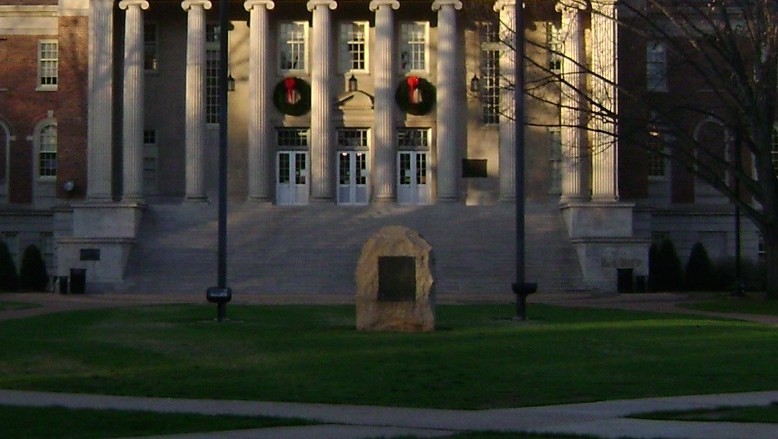 Sitting between the 1895 Alabama state flag and the United States flag, sits the UDC boulder. This is the second of two places it has been, having been moved from the site of the Rotunda ruins, roughly 10 meters behind. 