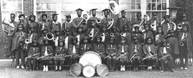 Three rows of students holding various instruments.