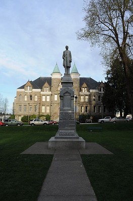 The statue is located next to the former state capitol within the center of Sylvester Park. 