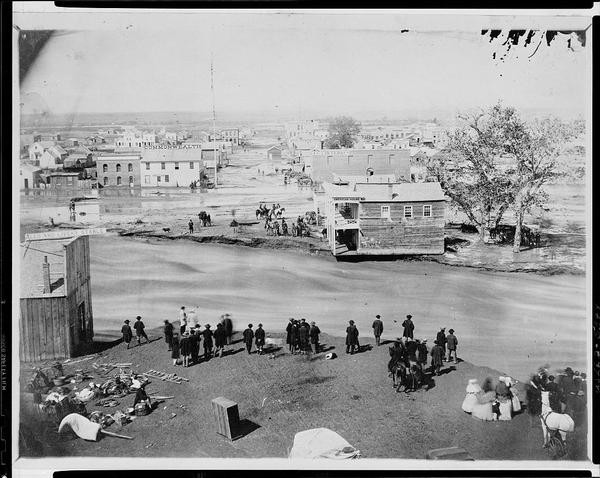 People stand on the banks of Cherry Creek during Denver's Great Flood on May 19, 1864. (From the Library of Congress Digital Archives)