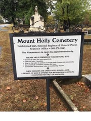 Signage with information regarding regulations of the cemetery and contact information for the sexton.Photo taken by Randall Crawford.