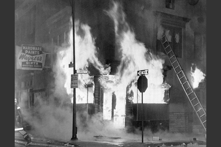 A fire engulfs a store in Baltimore on April 7, 1968. Photo by Bettmann/Corbis