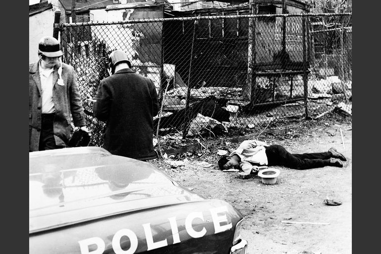 The body of James Harrison lies in an alleyway where a policeman shot him on April 8, 1968. Photo by Baltimore News-American/AP