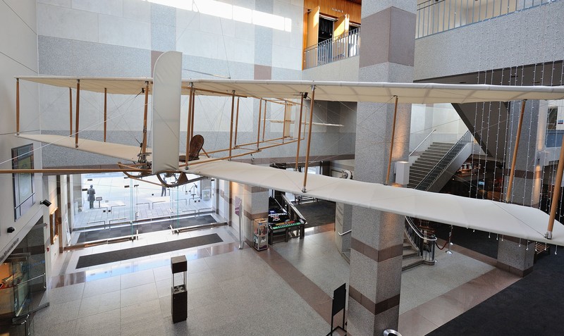 Visitors are welcomed to the museum by this replica of the Wright Brother's Glider, along with other exhibits in the museum lobby. 