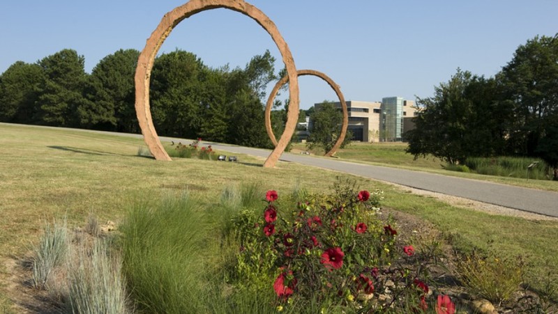 Gyre by Thomas Sayre. The name refers to "gyration" and features three elliptical trenches filled with concrete and steel bars.