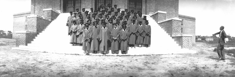 Members of the Williston High School Class of 1931 pose on the steps of a new building: the third Williston High School structure.