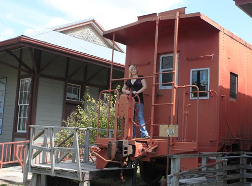 The vintage train caboose located behind the museum.