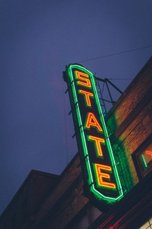 State Theatre sign illuminated at night.