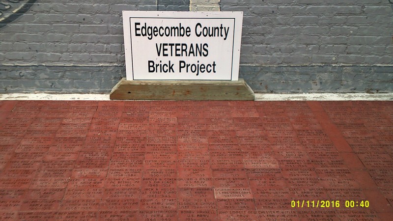 Memorial Bricks outside the Colonial Theater, beneath a memorial mural on the side of the theater