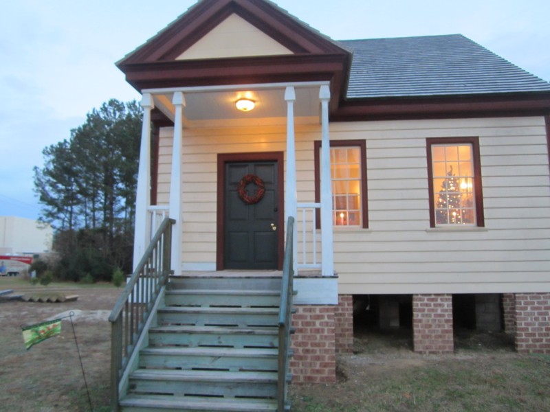 The exterior facade of the (ca 1810) farmhouse with a replicated front porch based on ghost marks discovered during the renovation.