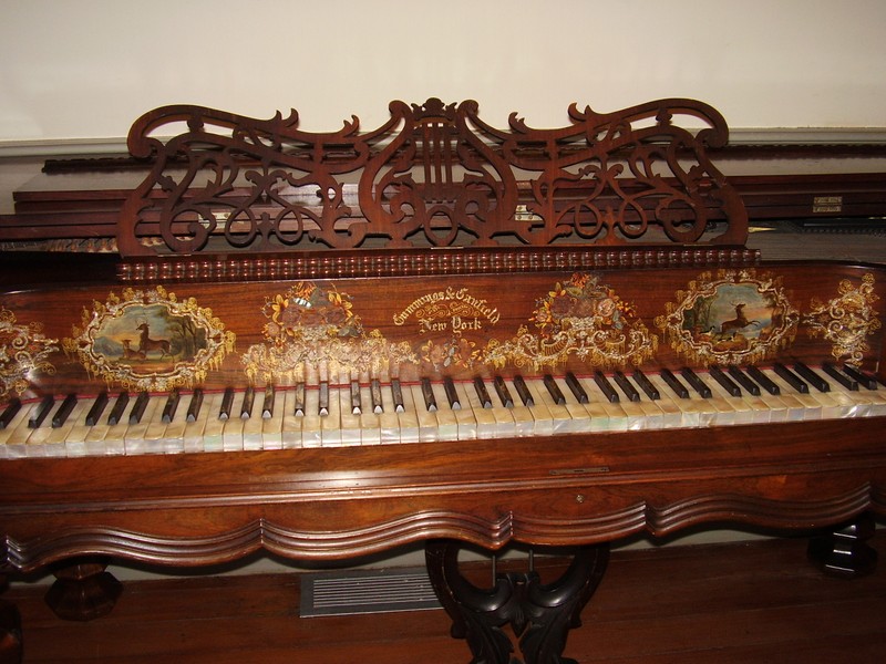 Cumming & Canfield piano ca 1855. Donated to the house by Alice Weeks Patrick. It has mother of pearl keys & gold leaf & mother of pearl inlay. It is one of only 5 such pianos known to exist.