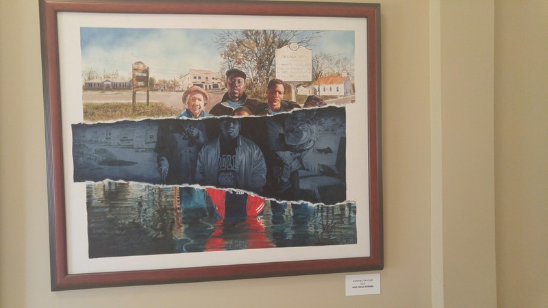 This painting, recalling how the flood divided the town, is on loan from Mrs. Delia Perkins that is in the main hall in the Princeville Museum. (photo by: Kayla Greene)