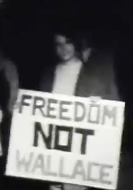 Another protestor shows off her sign outside the Wallace speech at the Civic Auditorium.