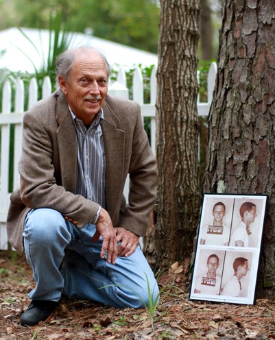 Former student Dan Harmeling poses with his mugshots following his arrest for civil rights activism in Gainesville. Dan was one of the UF students who physical blocked the entrance to the theater in protest of racial segregation. 