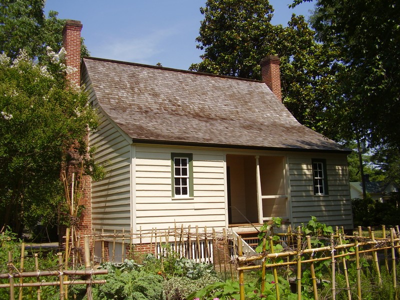 Behind the house is an herb or kitchen garden to demonstrate to visitors the types of plants used in hearth cooking.