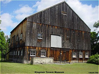 The historic barn that displays numerous vintage tools and farm implements.