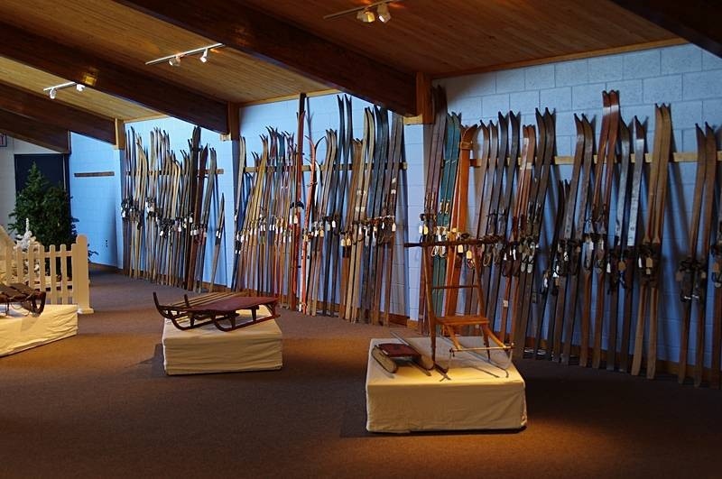 Several old skis and sleds on display
