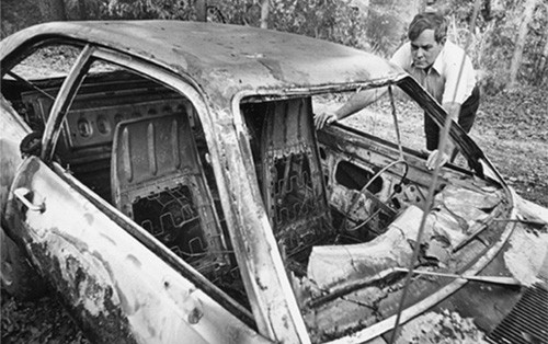 The controversy quickly escalated. Textbook protester Donald Means examines his burned car.