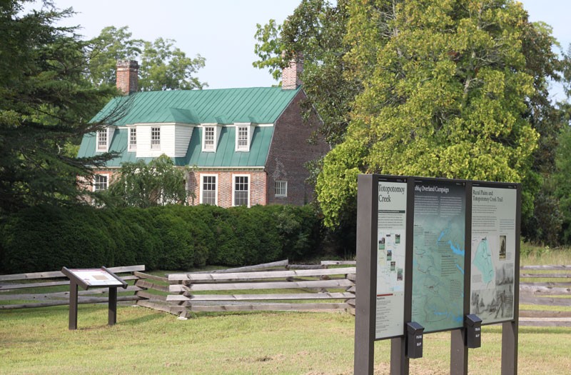 The Shelton House with interpretive signs in the foreground.