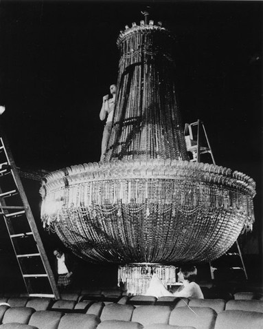 The Byrd's large chandelier lowered for cleaning.