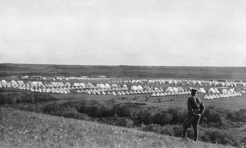 Black and white image of First Nations camp with rows of tipis