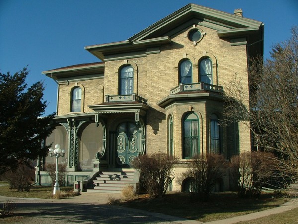 The style of the house is Italianate with a few Greek Revival flourishes thrown in, such as the triangular pediment on the facade.