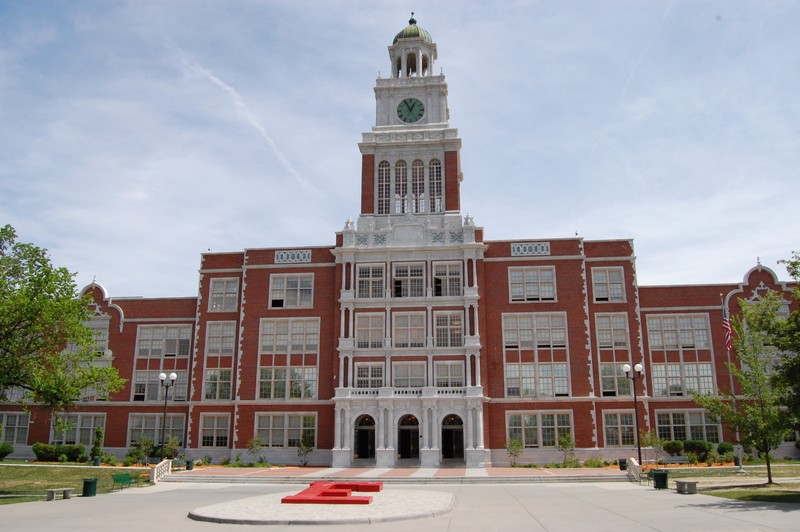 The red brick Jacobean-style building is located at 1600 City Park Esplanade, between Colfax Avenue and the southwestern corner of City Park.