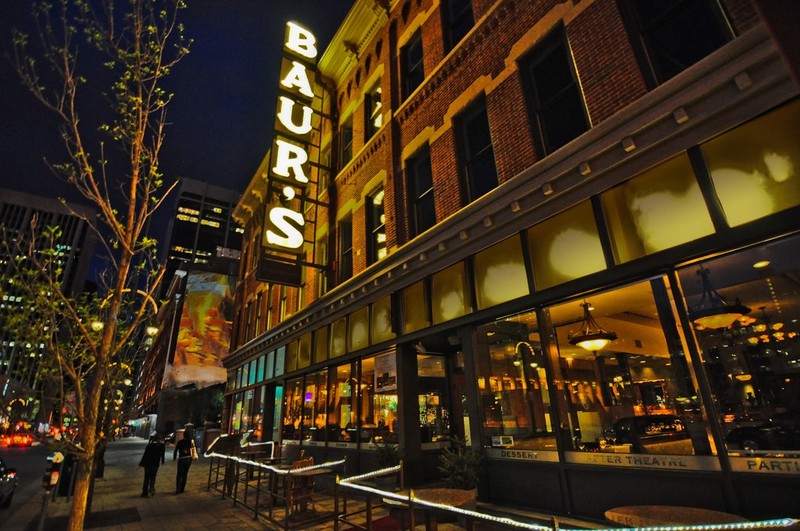 The restaurant and listening lounge with outdoor seating photographed at night.