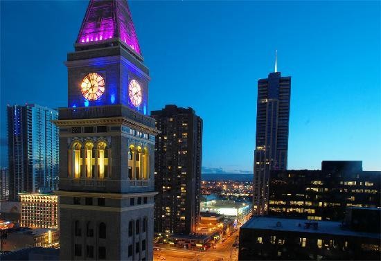 The tower set against the Denver skyline at night.