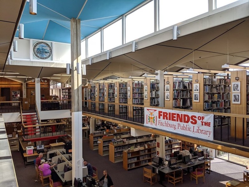 View of library book shelves, atrium and ceiling, with arched supports