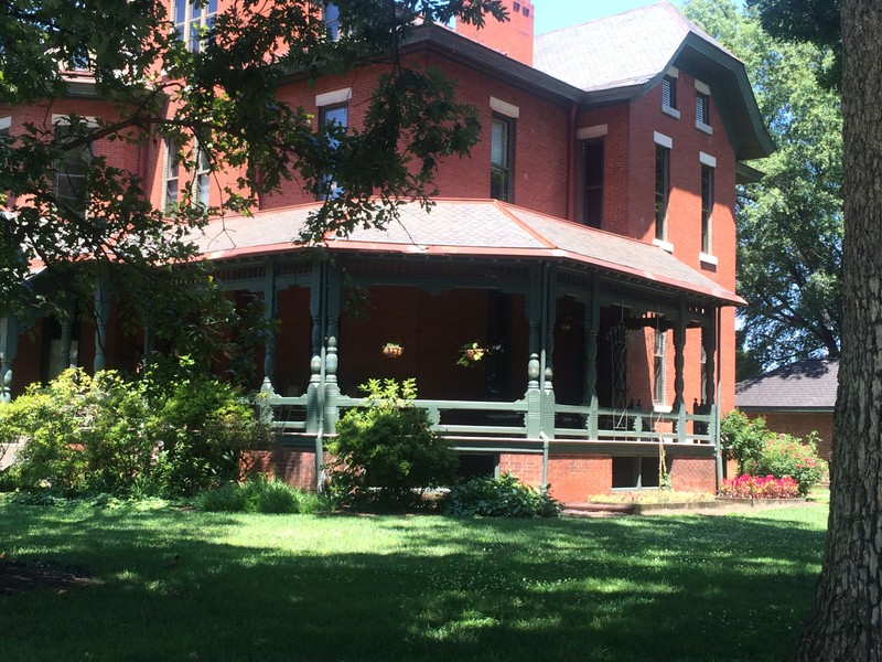 A view of the southern facade taken from an angle. This view showcases the verandah and some of the landscaping.